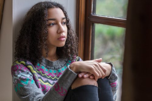 Young girl looking out the window with a sad expression on her face. 
Sexual violence awareness week 