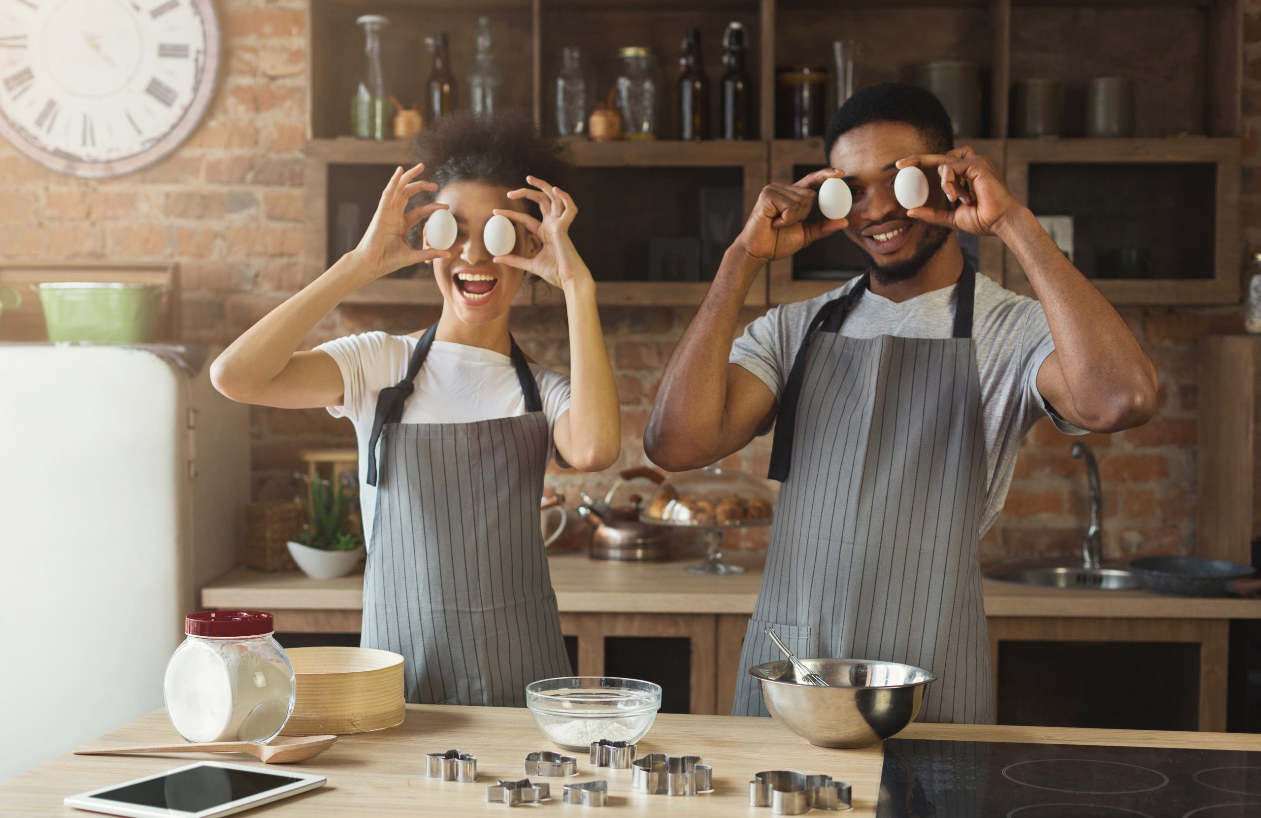 Happy,Black,Couple,Baking,Pie,And,Having,Fun,In,Loft