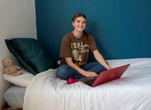 Room sponsorship - Becky sat on bed