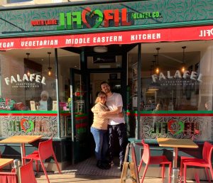 Chef Ben and owner Amal hugging outside Filfil cafe where they work