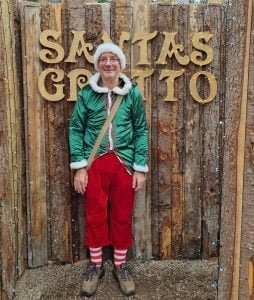 Santa's elf Clive smiling at the woodland entrance to Santa's grotto