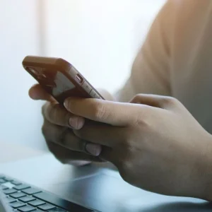young male hands holding mobile phone