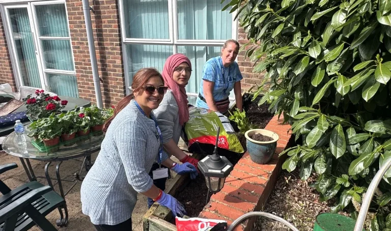 3 women working on the raised planters - websize