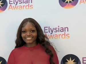 Michelle head and shoulders in front of branded background