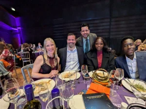 The group sit around the table with their meal