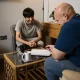 young man and adult name chatting around coffee