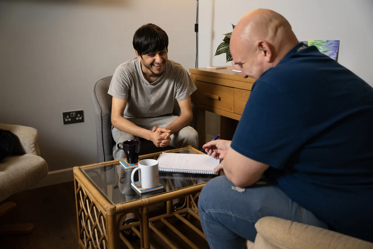 young man and adult name chatting around coffee