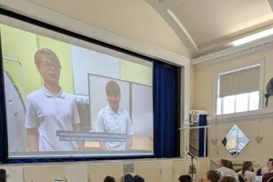 two children seen on large screen
