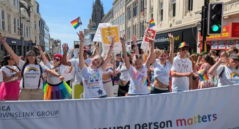 YMCA DownsLink group marching at Brighton Pride 2026, behind a banner reading 'Every young person matters'