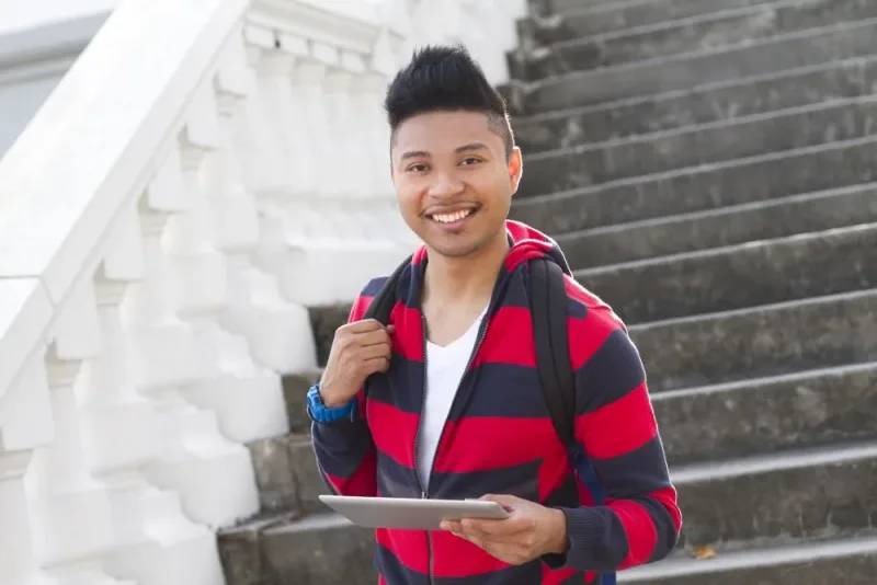 young man in striped black and red hoodie