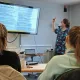 man pointing at a screen while delivering training