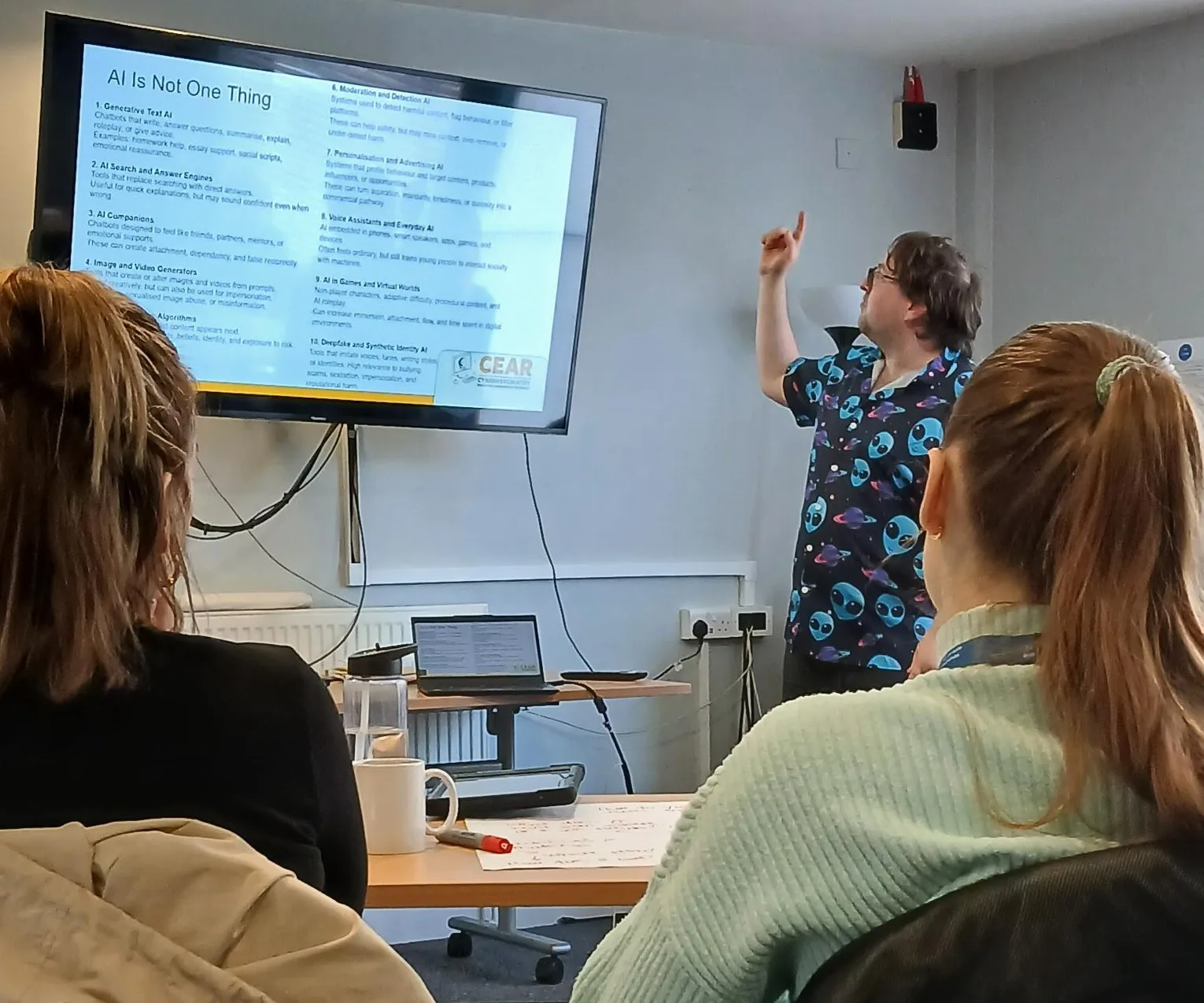 man pointing at a screen while delivering training