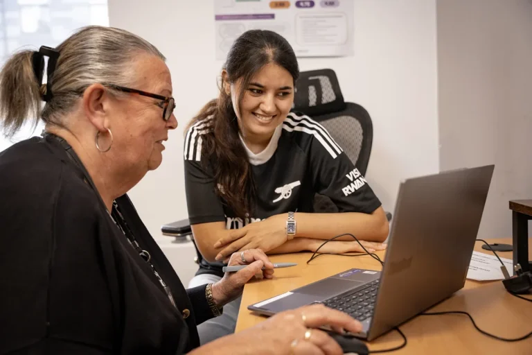woman and girl looking at a laptop