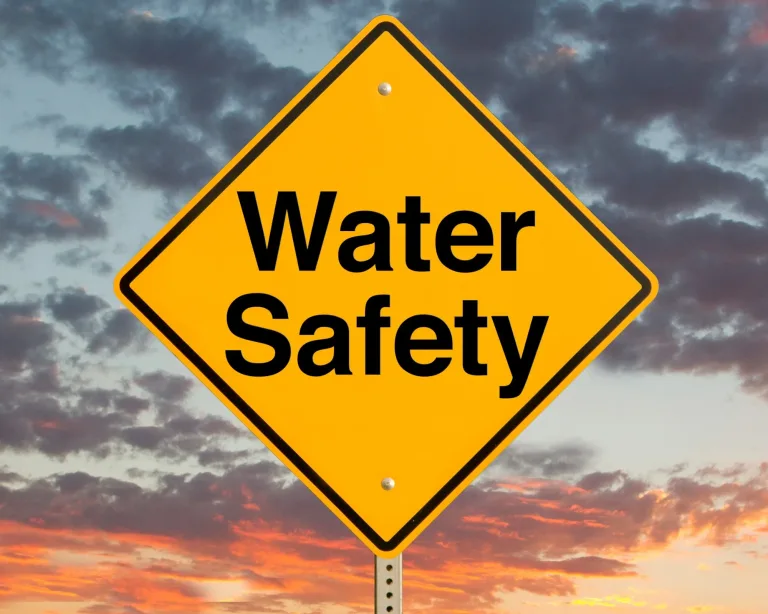 water safety sign against dramatic sky backdrop