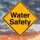 water safety sign against dramatic sky backdrop