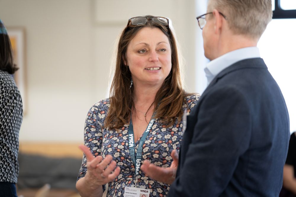 Two people talking at WMHD event
