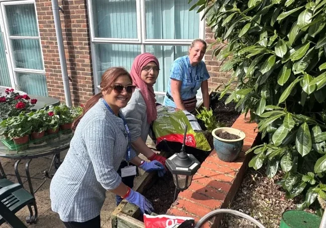 3 women working on the raised planters - websize