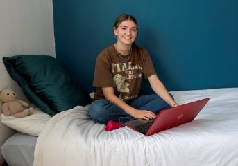 Room sponsorship - Becky sat on bed