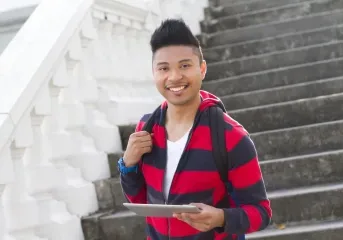 young man in striped black and red hoodie