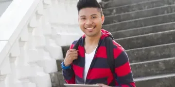 young man in striped black and red hoodie