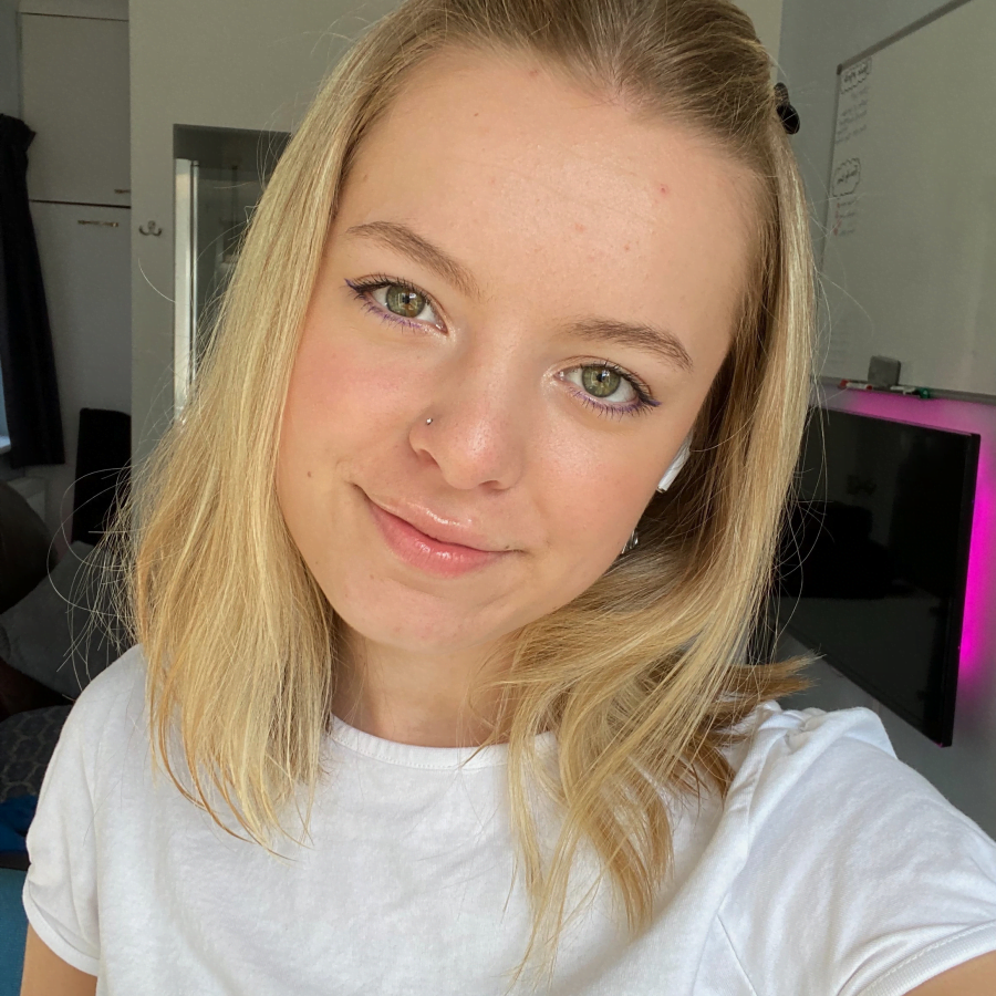 MicrosoftTeams-image (73) Mollie wearing a white shirt smiling taking a selfie