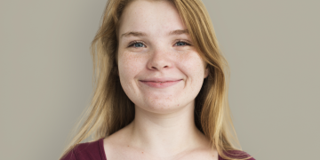 Stacy image Stacy, a teenage girl with blonde hair smiling, wearing a red top.