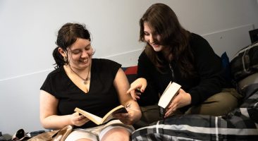 tenant satisfaction featured image. two girls sat on a bed reading together
