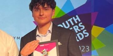 YMCA Youth Matters Awards event_ Randy Randy at the Youth Matters Awards smiling holding his certificate