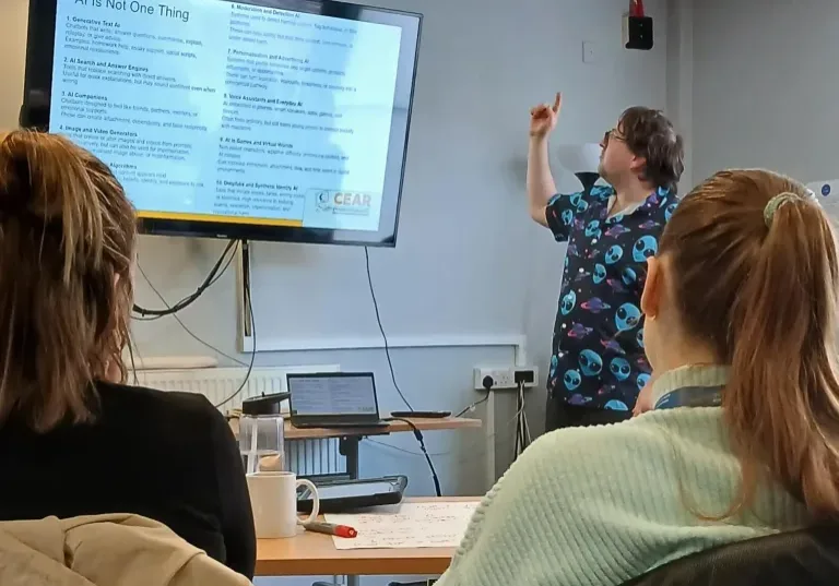 man pointing at a screen while delivering training