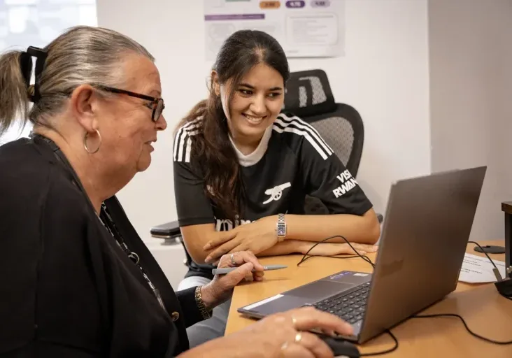 woman and girl looking at a laptop