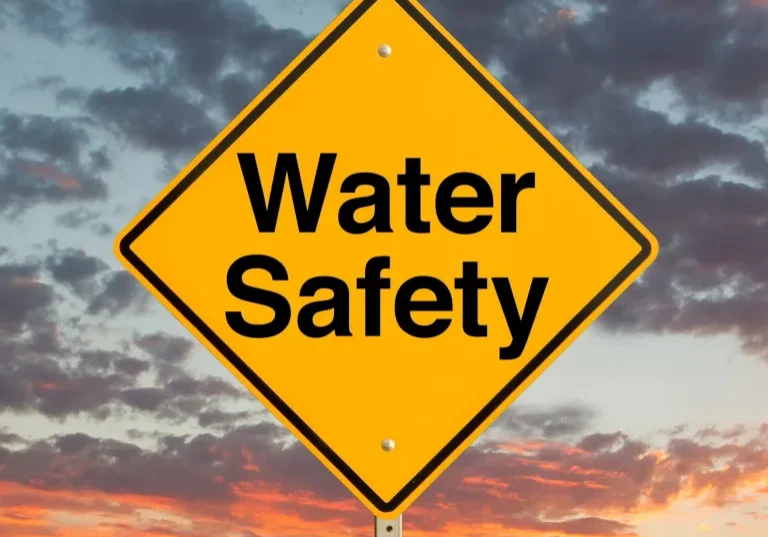 water safety sign against dramatic sky backdrop
